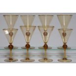A SET OF EIGHT AMBER AMBER AND GILT GLASS WINE GLASSES, EARLY 20TH C, IN TWO SIZES, THE FLARED