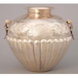 A GREEK SILVER REPOUSSE AND LOBED GLOBULAR VASE, 20TH C, CHASED WITH GRAPES, CAST LEAF HANDLES, 15CM