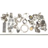 A SILVER CHARM BRACELET AND   MISCELLANEOUS SILVER JEWELLERY, INCLUDING AN INGOT PENDANT, 4OZS