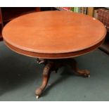 A VICTORIAN MAHOGANY BREAKFAST TABLE, C1880, ON THREE CABOCHON CARVED SCROLLING LEGS AND VOLUTE FEET