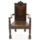 AN OAK PANEL BACK ARMCHAIR, 19TH C,  IN 17TH C STYLE WITH SHAPED ARMS, BOARDED SEAT AND TURNED
