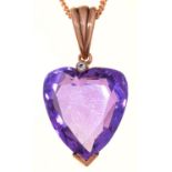 A HEART SHAPED AMETHYST PENDANT, EARLY 20TH C WITH DIAMOND ACCENT, GOLD LOOP, 29MM OVERALL AND A