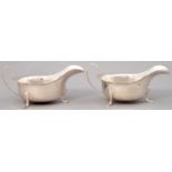 A PAIR OF GEORGE V SILVER SAUCE BOATS ON THREE FEET, 14.5CM L, BY VINERS LTD, SHEFFIELD 1933 AND 34,