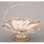 A VICTORIAN SILVER CAKE BASKET, OF SPIRALLY LOBED FORM,  CHASED AND APPLIED WITH C SCROLLS AND