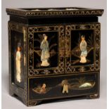 A SOUTH EAST ASIAN LACQUER TABLE CABINET, APPLIED WITH POLYCHROME SOAPSTONE RELIEFS OF YOUNG