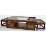 A STAINED WOOD AND CANED NEST OF TABLES, THE LARGEST WITH CINNAMON GLASS TOP, LATE 20TH C, 47CM H;