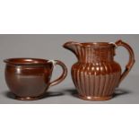 A DERBYSHIRE SALTGLAZED BROWN STONEWARE HANDLED POT OR PORRINGER AND A JUG, BOTH BRAMPTON,LATE