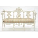 A CARVED OAK SETTEE, LATE 19TH C, WITH MASKS AND GROTESQUES, SEAT HEIGHT 40CM, 146CM W, WHITE