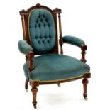 A VICTORIAN WALNUT ARMCHAIR, THE BREAKARCHED BUTTONED BACK WITH RIBBON CARVED CRESTING AND FLUTED