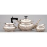 A GEORGE V GADROONED SILVER MATCHED TEA SERVICE, TEAPOT 12.5CM H, BY W & F RABONE, BIRMINGHAM