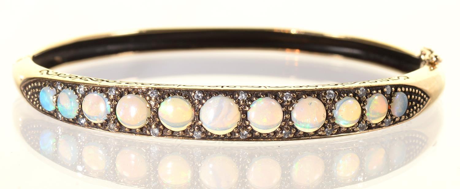 AN OPAL AND WHITE STONE BANGLE IN 9CT GOLD, 58 X 64MM, BIRMINGHAM 2001, 13.5G Good condition