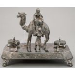 A VICTORIAN ORIENTALIST BRITANNIA METAL INKSTAND, THE BASE SET WITH CAST FIGURES OF ARAB TRIBESMEN