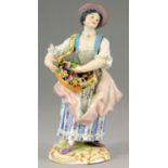 A MEISSEN FIGURE OF A GIRL WITH A BASKET OF FLOWERS, 20TH C; 15.5CM H, IMPRESSED 36 AND 81,