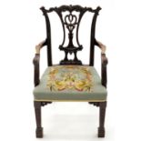 A CARVED MAHOGANY ELBOW CHAIR, C1900, IN GEORGE II STYLE, THE STUFFED OVER WOOLWORK SEAT WITH BIRD