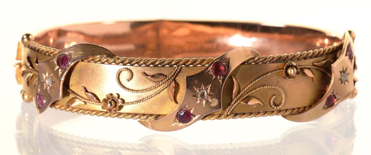 A RUBY AND DIAMOND BANGLE, GIPSY SET AND APPLIED WITH FILIGREE, IN 9CT GOLD, 57 X 71MM, MAKER S BROS