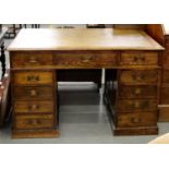 AN OAK PEDESTAL DESK, C1920, FITTED NINE DRAWERS WITH OXIDISED ART METAL HANDLES, THE SIDES