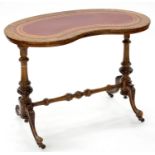 A VICTORIAN KIDNEY SHAPED WALNUT WRITING TABLE WITH GILT TOOLED RED LEATHER INLET SURFACE, ON TURNED