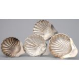 FOUR EDWARDIAN AND GEORGE V SILVER BUTTER SHELLS, THREE ON THREE FEET, CIRCA 10-11.5CM L, BY VARIOUS