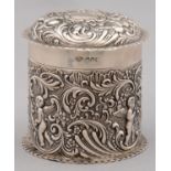 A GEORGE V CYLINDRICAL SILVER CANISTER AND COVER, DIE STAMPED WITH PUTTI AND ROCAILLE, CRIMPED RIMS,