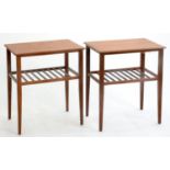 A NEAR PAIR OF TEAK TWO TIER TABLES, C1970'S, THE ROUNDED RECTANGULAR TOPS ABOVE RAILED UNDERTIERS