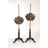 A PAIR OF VICTORIAN JAPANNED POLE SCREENS, C1840, THE EBONISED POLE WITH TURNED FINIAL AND BATWING