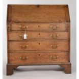 A GEORGE III OAK BUREAU, C1780, THE FALL-FLAP REVEALING CONVENTIONALLY FITTED INTERIOR OF PIGEON