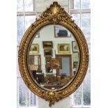 AN OVAL GILT FRAMED MIRROR, IN VICTORIAN STYLE, WITH BEVELLED PLATE, 148CM H GOOD CONDITION