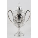 AN IRISH GEORGE III SILVER CUP AND COVER, OF SHIELD SHAPE WITH VASE FINIAL, LATER CHASED WITH