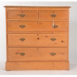 A VICTORIAN PINE CHEST OF TWO SHORT OVER THREE LONG GRADUATED DRAWERS, SKIRTED BASE, BRASS