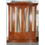 A REPRODUCTION CONTINENTAL BURR WALNUT VENEERED DISPLAY CABINET OF SHALLOW SERPENTINE FORM, THE