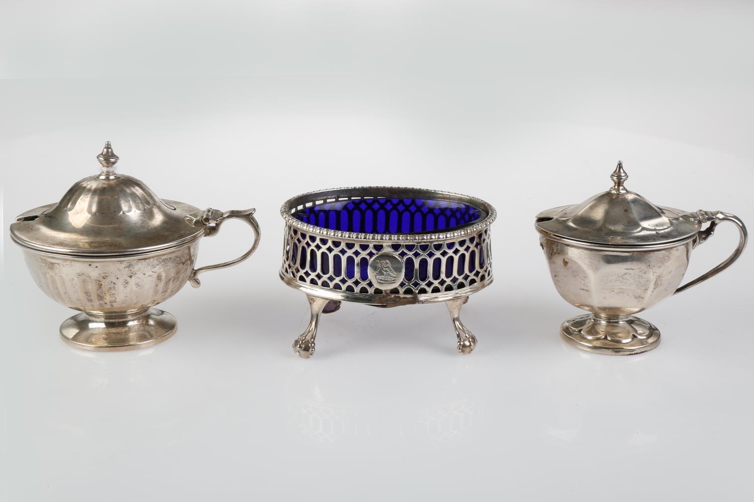 A GEORGE III PIERCED OVAL SILVER SALT CELLAR, BLUE GLASS LINER, CRESTED, 80MM L, MARKS RUBBED, BY