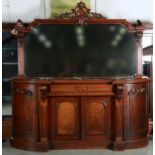 A VICTORIAN MAHOGANY BREAKFRONT MIRROR BACK SIDEBOARD, THE PANELLED BOWED ENDS APPLIED CARVED