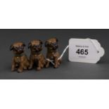 A CONTINENTAL OLD PAINTED BRONZE MINIATURE SCULPTURE OF THREE PUG DOGS, EACH IN A BLUE RIBBON,