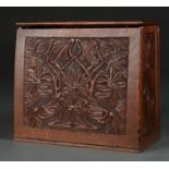 A CARVED OAK STATIONERY BOX, THE HINGED LID AND FRONT RELIEF CARVED WITH LEAFAGE ON A MATTED GROUND,