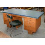 A CONTINENTAL MID CENTURY OAK DESK WITH BLUE FABRIC COVERED SURFACE AND ALUMINIUM BEADING, 75CM H;
