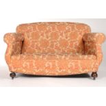 AN UPHOLSTERED TWO SEAT SOFA WITH S-SCROLL ARMS, BOWED APRON ON MAHOGANY STAINED BULBOUS WOODEN FEET
