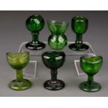 EIGHTEEN MOULDED BLUE, GREEN AND CLEAR GLASS EYE BATHS, MOSTLY 19TH/EARLY 20TH C, VARIOUS SIZES