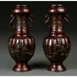 A PAIR OF JAPANESE BRONZE TWO HANDLED VASES, THE DEEPLY LOBED BODIES WITH FINCHES AND PRUNUS BLOSSOM