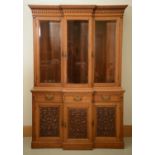 A VICTORIAN OAK BREAKFRONT BOOKCASE, C1880, THE FLUTED, FLARED CORNICE WITH DENTIL MOULDED FRIEZE