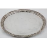 AN AUSTRO-HUNGARIAN SILVER SALVER, WITH PLAIN FIELD AND NEO CLASSICAL STYLE CAST OPENWORK BORDER
