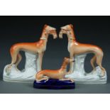 A PAIR OF STAFFORDSHIRE EARTHENWARE MODELS OF GREYHOUNDS, C1860, ON SPRIGGED BASE, 28CM H  AND  A