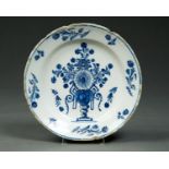 A NORTHERN EUROPEAN TIN GLAZED EARTHENWARE DISH, LATE 18TH C, PAINTED IN BLUE OUTLINED IN BLACK WITH