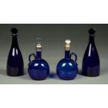 A PAIR OF BLUE GLASS MALLET SHAPED DECANTERS AND FACETED STOPPERS, 19TH / 20TH C, IN REGENCY