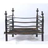 A SERPENTINE WROUGHT IRON BASKET GRATE, 20TH C, WITH VASE FINIALS, 33CM H; 33 X 52CM Good condition