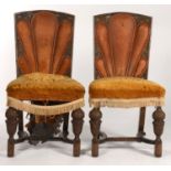 A PAIR OF OAK ART DECO STYLE DINING CHAIRS, WITH FLORAL CARVED BACKS WITH STUFFED OVER BROWN LEATHER