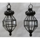 A PAIR OF OXIDISED METAL AND GLAZED OCTAGONAL LANTERNS, WITH FOLIATE CORONAS AND PENDANT BASES, 52CM