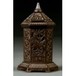 A VICTORIAN CAST IRON BANK OF HEXAGONAL PILLAR SHAPE, WITH DOMED COVER, PIERCED TO EITHER SIDE AND