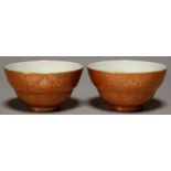 A PAIR OF CHINESE CORAL GROUND AND GILT BOWLS, 19TH / 20TH CENTURY, DECORATED WITH AUSPICIOUS