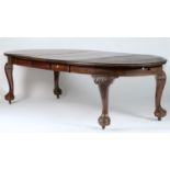 A MAHOGANY THREE LEAF EXTENDING DINING TABLE IN GEORGE III STYLE, THE OVAL TOP ABOVE A DEEP FRIEZE