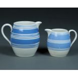 TWO GRADUATED BLUE BANDED WHITE EARTHENWARE BARREL SHAPED JUGS, EARLY 20TH C, 14 AND 18.5CM H,
